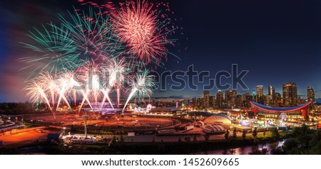 Fireworks display over the night sky with the Calgary downtown skyline in the backdrop during the annual Stampede festivities.