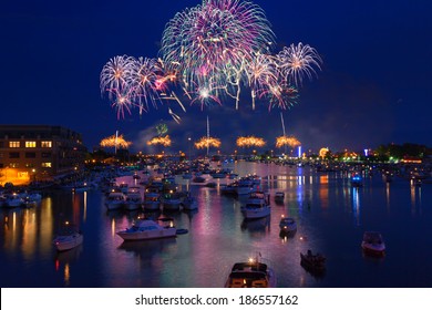 Fireworks explode in a glorious display over the Saginaw River at Bay City Michigan's annual fireworks show. Crowds gather in boats on the river to watch the display and celebrate Independence Day.
