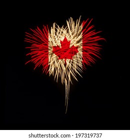 Fireworks in a heart shape with the Canada flag on a black background. Canada day. Welcome to Canada