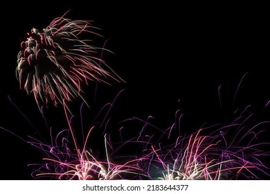 fireworks at night pyrotechnics sky explosions celebration bright glowing light background