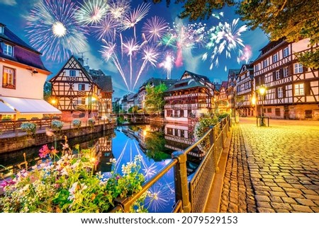 Fireworks at the old town water canal panorama of Strasbourg, Alsace, France. Traditional half timbered houses of Petite France
