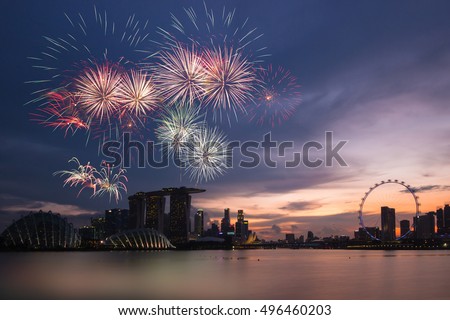 Fireworks over bay ,Silhouette building during sunset and sky twilight at Singapore on National day rehearsal 