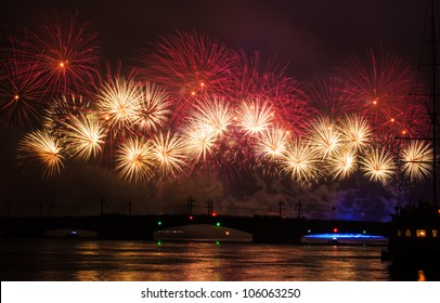 Fireworks over the city of St. Petersburg (Russia) on the feast of "Scarlet Sails", in the rain with fog and smoke. View of the Palace Bridge with people and part of the sailboat. - Powered by Shutterstock