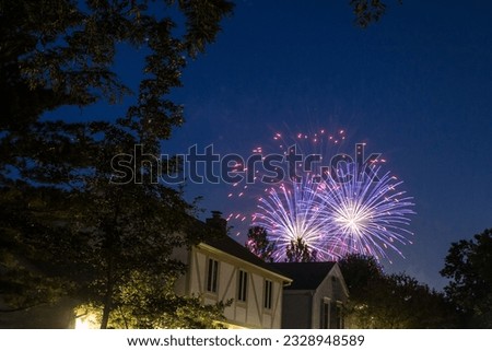 Fireworks Seen Over Houses in a Neighborhood