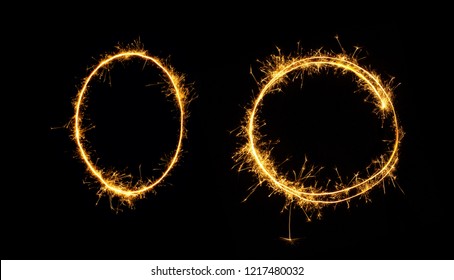 Fireworks zero number close up. Burning sparkler in the shape of oval and circle isolated on black background. Object of Sparklers to overlay a texture for design Holiday postcards, web banners