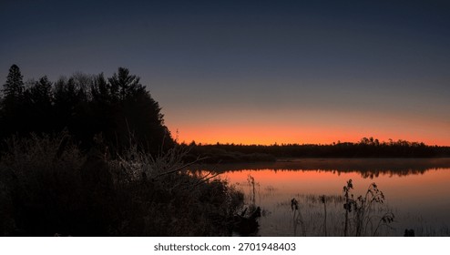 firey sunrise in marsh with reflection 