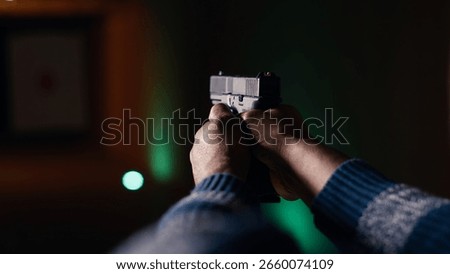 Firing range customer doing shooting activity with pistol, checking if he shot bullseye. Close up of person in shooting gallery learning how to use firearm, analyzing targets shot, camera B