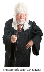 Firm, Angry British Style Judge With White Wig, Waving His Gavel.  Isolated On White.