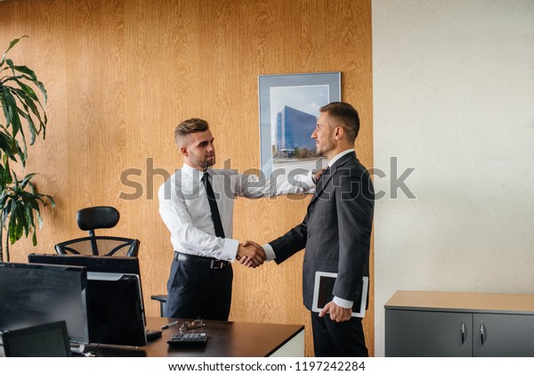 A firm handshake after a successful transaction.\
Business. Finance.