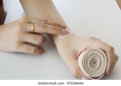 first aid accident wrist with liniment - Shutterstock ID 372260656