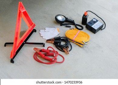 First Aid Car Emergency Kit, Gloves, Flashlight, Safety Triangle, Car Air Compressor, Battery Jumper Cable, Rope