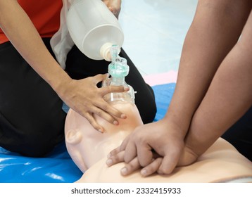 First aid CPR chest pumping. Instructor showing resuscitation technique with holding oxygen mask. Basic life support training. - Powered by Shutterstock