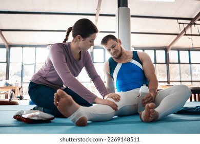 First aid, injury and man with leg pain in gym after accident, workout or exercise. Fitness health, physiotherapist woman or male gymnast or athlete with fibromyalgia, inflammation or painful muscles - Powered by Shutterstock