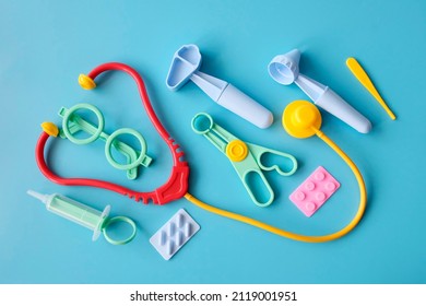 First Aid Kit For Children, Toy Medical Instruments. Game Set For Development Concept. Blue Background.