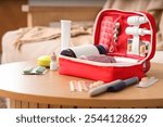 First aid kit with medicines on table in living room