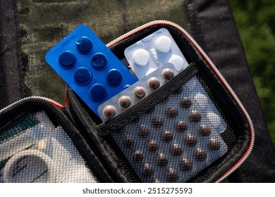 A first aid kit that contains various pills and medication to help treat minor injuries and ailments effectively in emergencies, ensuring you are prepared for unexpected situations - Powered by Shutterstock