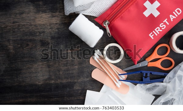 First aid medical kit on wood background,copy\
space,top view