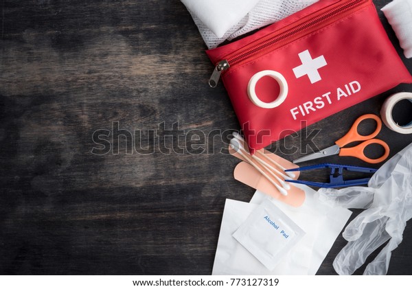 First aid medical kit on wood background,copy\
space,top view