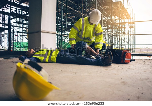 First aid support accident in site work,\
Builder accident fall scaffolding to the floor, Safety team help\
employee accident.