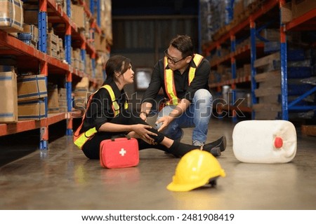 First aid support accident at work of worker at factory. Male worker has an accident on the floor in warehouse site