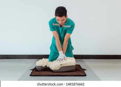 First aid Training by hand. First Aid course in CPR dummy. Concept of training skills to save lives. - Powered by Shutterstock