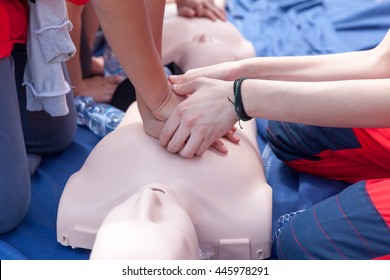 First aid training. Cardiopulmonary resuscitation (CPR) being performed on a medical-training manikin.