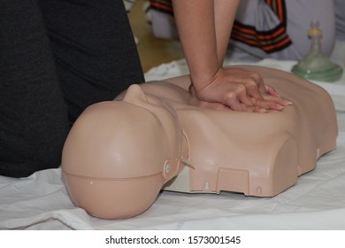 First Aid Training - CPR Training Medical Procedure, Demonstrating Chest Compressions On CPR Doll In The Class.