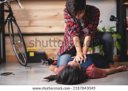 First aids emergency CPR on heart attack woman laying unconscious in home, One part of the process resuscitation - healthcare and insurance concept.
