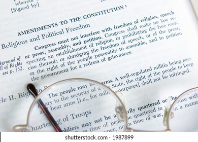 The First Amendment to the Constitution is shown on the page of a history book.