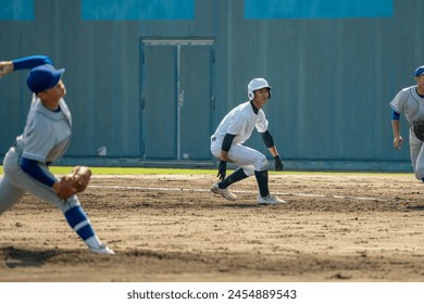 A first base runner taking a big lead (high school baseball)