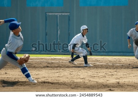 A first base runner taking a big lead (high school baseball)