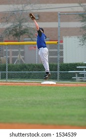 First baseman jumps to catch ball