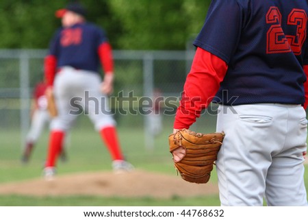 First baseman and pitcher on the mound during baseball game.