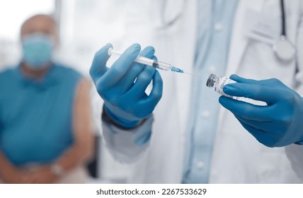 The first batch of vaccinations is being rolled out. Cropped shot of an unrecognizable male doctor preparing the covid 19 vaccination for a patient.