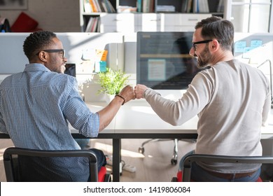 First bump between colleagues at work. Success in business. Everyday work in the office.