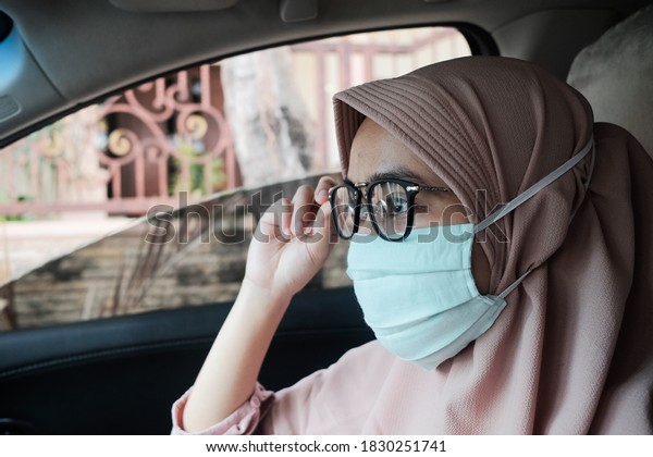 First Car.\
Cheerful Young Muslim Woman In Hijab Driving Her New Auto, Enjoying\
Ride In City, Wearing Stylish\
Glasses