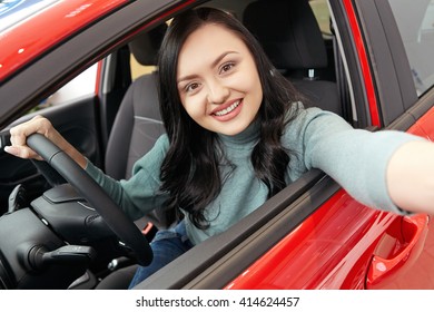 First Car Selfie. Gorgeous Cheerful Female Sitting In Her New Car Making A Selfie With Her Phone