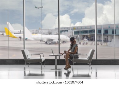 First Class Business Passenger Sitting In Luxury VIP Exclusive Lounge At Airport, On Laptop