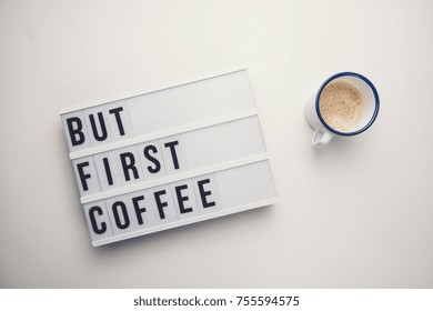 But First Coffee displayed on a vintage lightbox with coffee cup, concept image