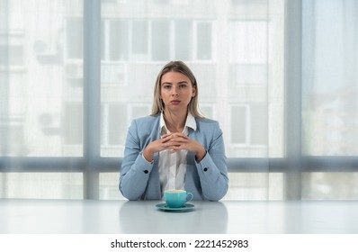 But First Coffee. Young Tired Business Woman In Formal Wear Sitting In The Office At Empty Desk With Cup Of Coffee. Female White Collar Worker, Freelancer Financial Expert Morning Routine.