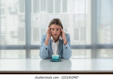 But First Coffee. Young Tired Business Woman In Formal Wear Sitting In The Office At Empty Desk With Cup Of Coffee. Female White Collar Worker, Freelancer Financial Expert Morning Routine.