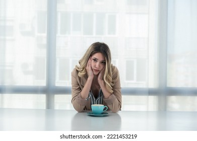 But First Coffee. Young Tired Business Woman In Formal Wear Sitting In The Office At Empty Desk With Cup Of Coffee. Female White Collar Worker, Freelancer Financial Expert Morning Routine.