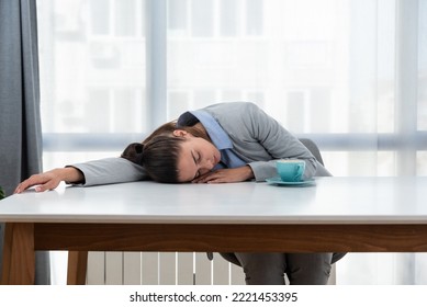 But First Coffee. Young Tired Business Woman In Formal Wear Sitting In The Office At Empty Desk With Cup Of Coffee. Female White Collar Worker, Freelancer Financial Expert Morning Routine.