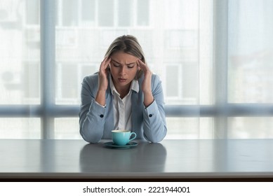 But First Coffee. Young Unhappy Tired Business Woman In Formal Wear Sitting In The Office At Empty Desk With Cup Of Coffee. Female White Collar Worker, Freelancer Financial Expert Morning Routine.