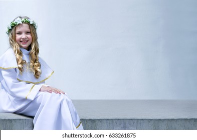First Communion beautiful young girl on the white background