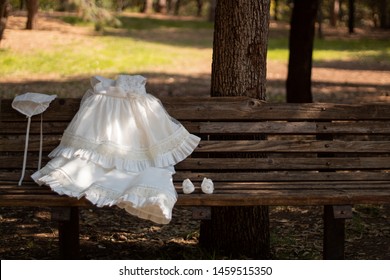 First Communion Suit Laid On A Wooden Bench
