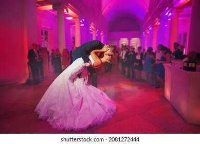 first dance - Elegant wedding by night. Groom kisses the bride in a waltz