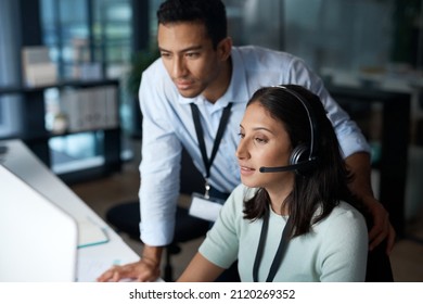 First day in the customer service field. Shot of a young man and woman using a computer while working in a call centre.