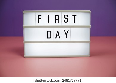 First Day letterboard text on LED Lightbox on pink and purple background - Powered by Shutterstock