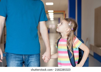 First Day At School. Father And Daughter Holding Hands. Child Girl With Parent In School Corridor. Happy Kid Going To First Grade Of Primary School. Concept Of Back To School, Confidence, Support